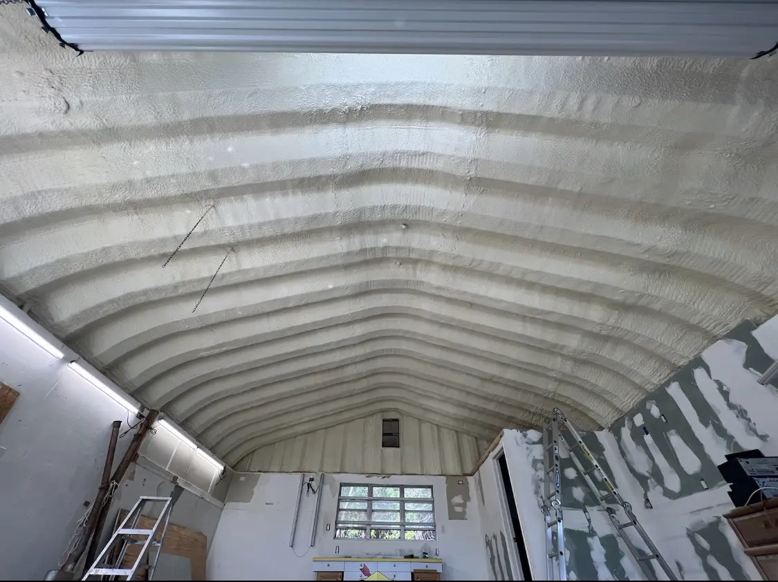 Spray polyurethane foam applied to the underside of a metal roof deck in Plymouth